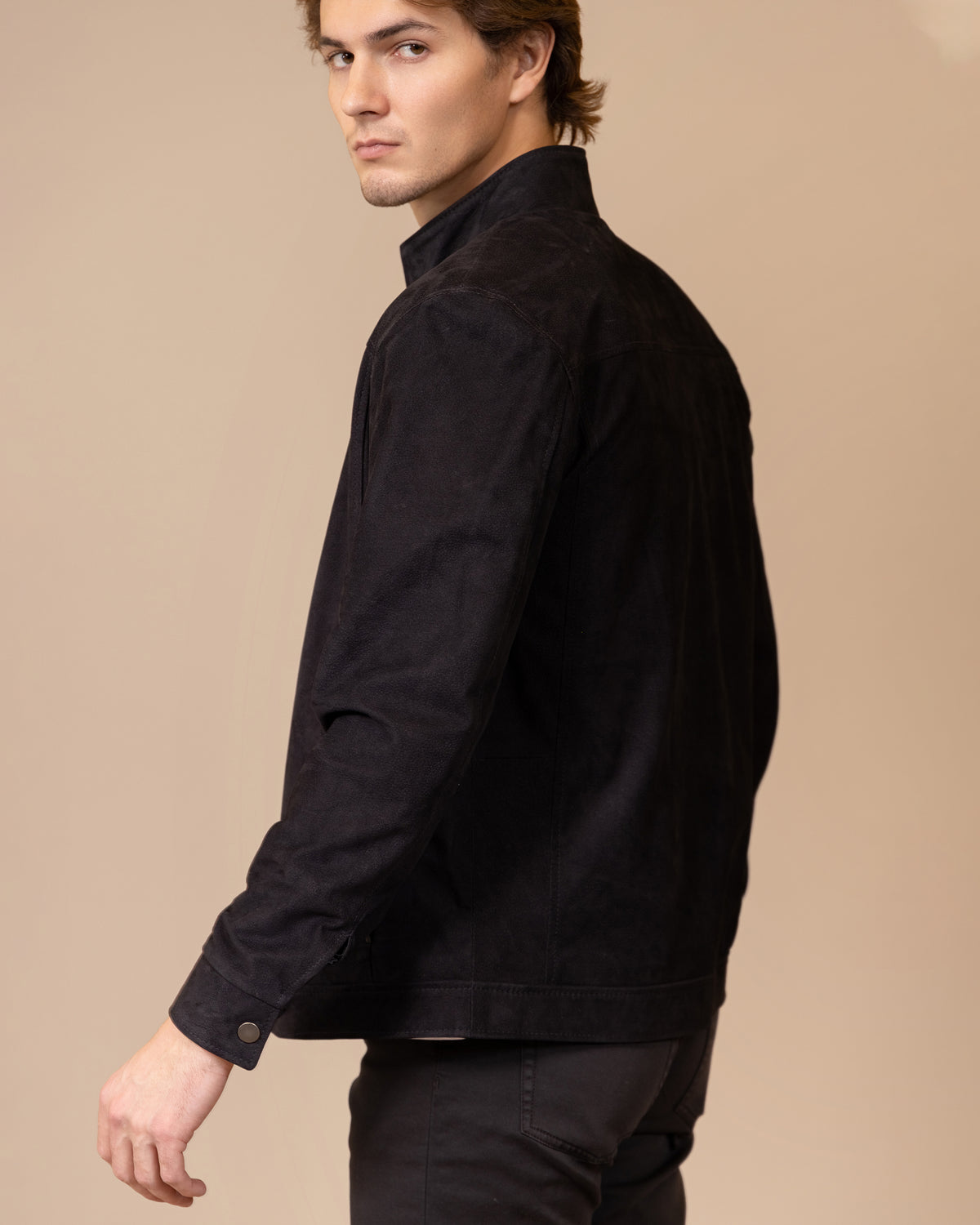 Side profile view of the Savio Ace Rustic nubuck calfskin jacket, highlighting the fitted cut and natural texture of the leather.