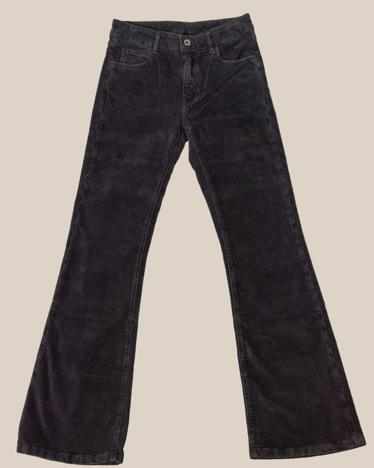 Black flared jeans on a light gray background