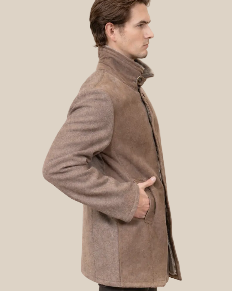 Man wearing a brown coat against a beige background