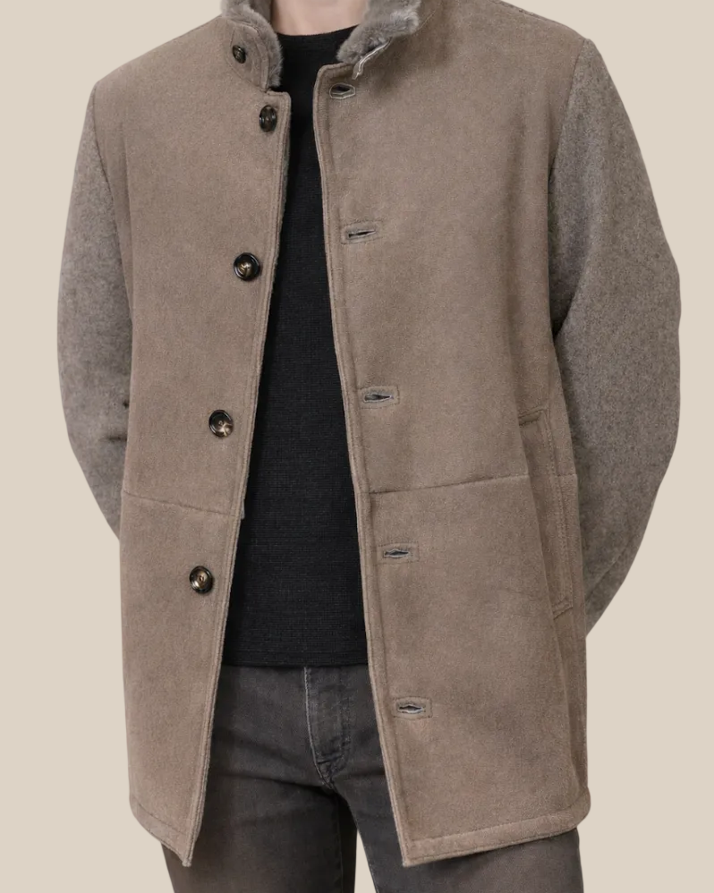 Brown coat worn by a person on a beige background