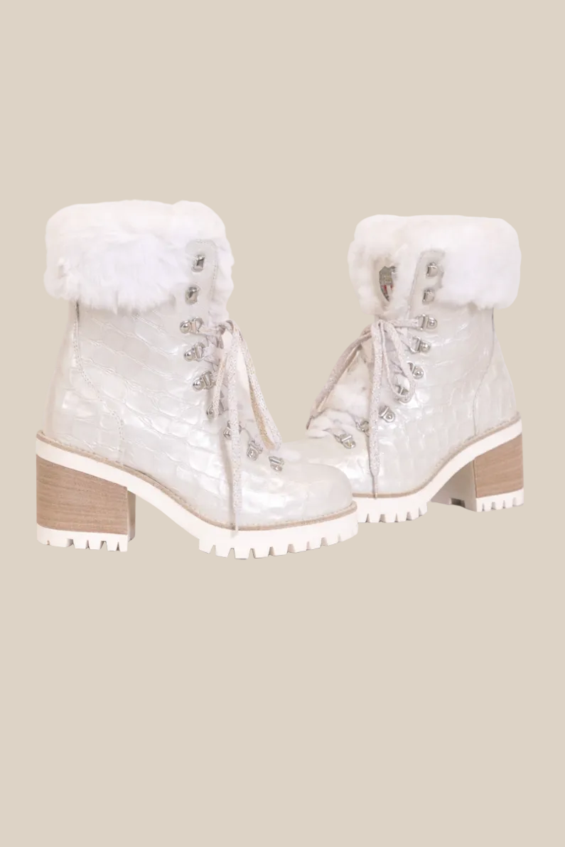 White winter boots with fur accents on a white background