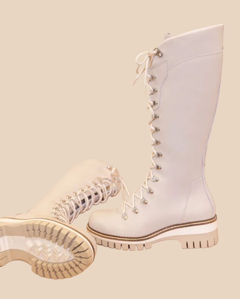 White lace-up boots on a beige background