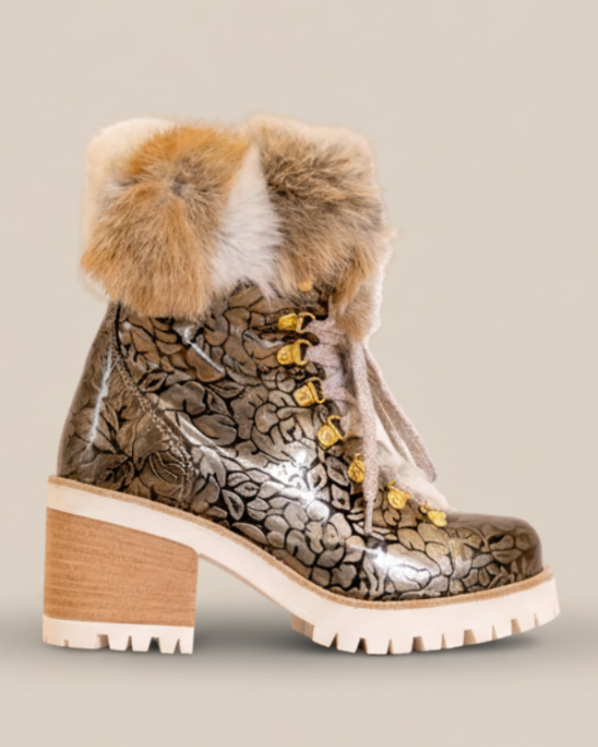 Metallic ankle boot with fur trim on a white background