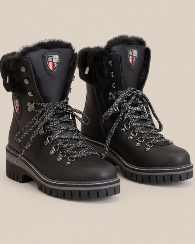Pair of black winter boots with fur lining on a white background