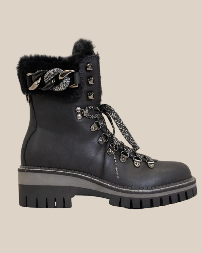 Black boot with fur trim and decorative elements on a white background