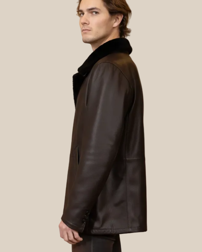 Man wearing a dark leather coat on a beige background