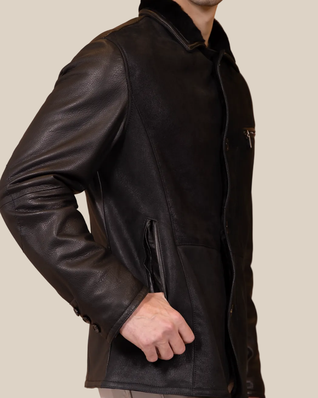 Man wearing a black leather jacket on a brown background
