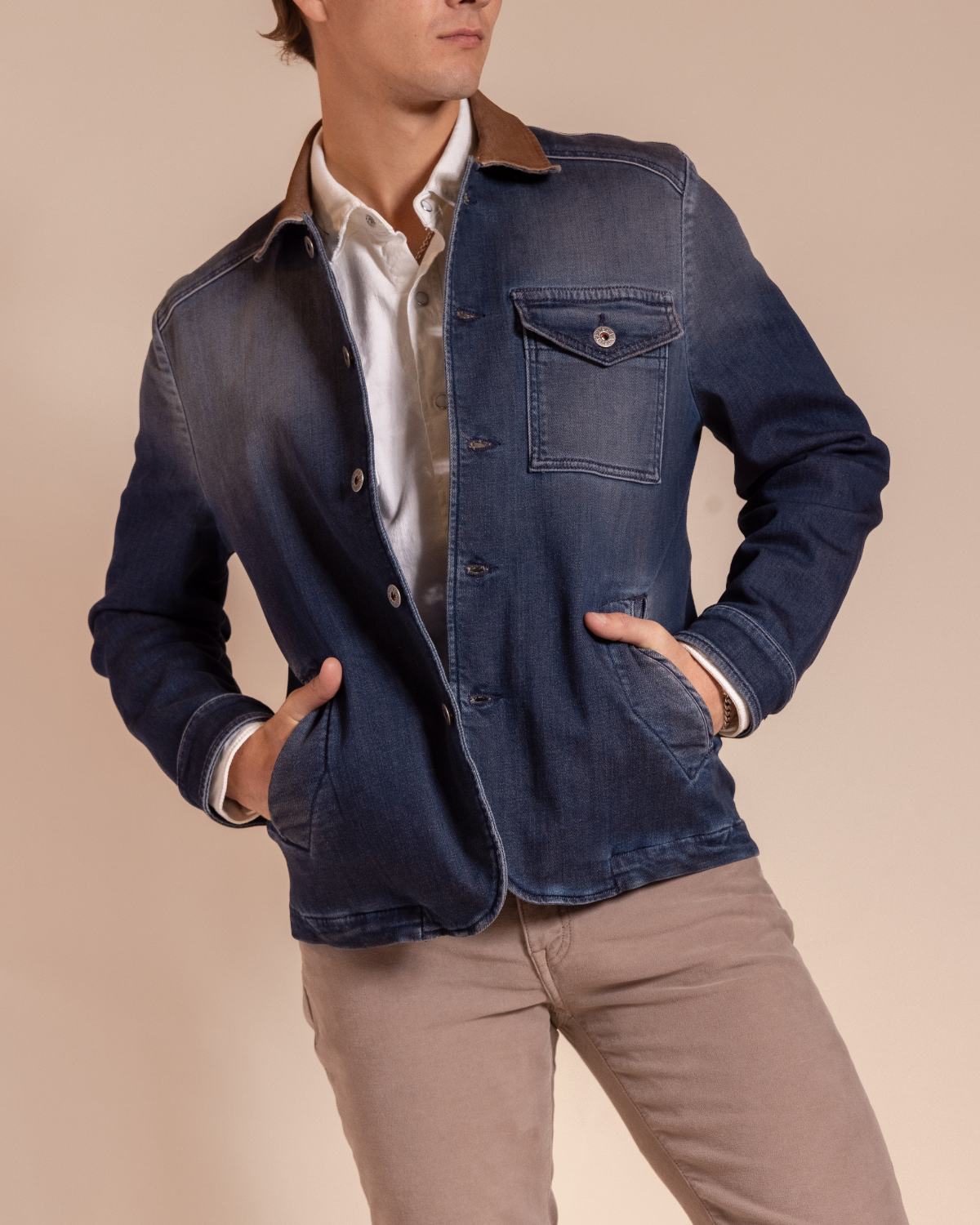 Hyde Dutton garment-dyed indigo denim jacket, side view — men's Italian Western jacket with tobacco corduroy collar, worn open over a white shirt.