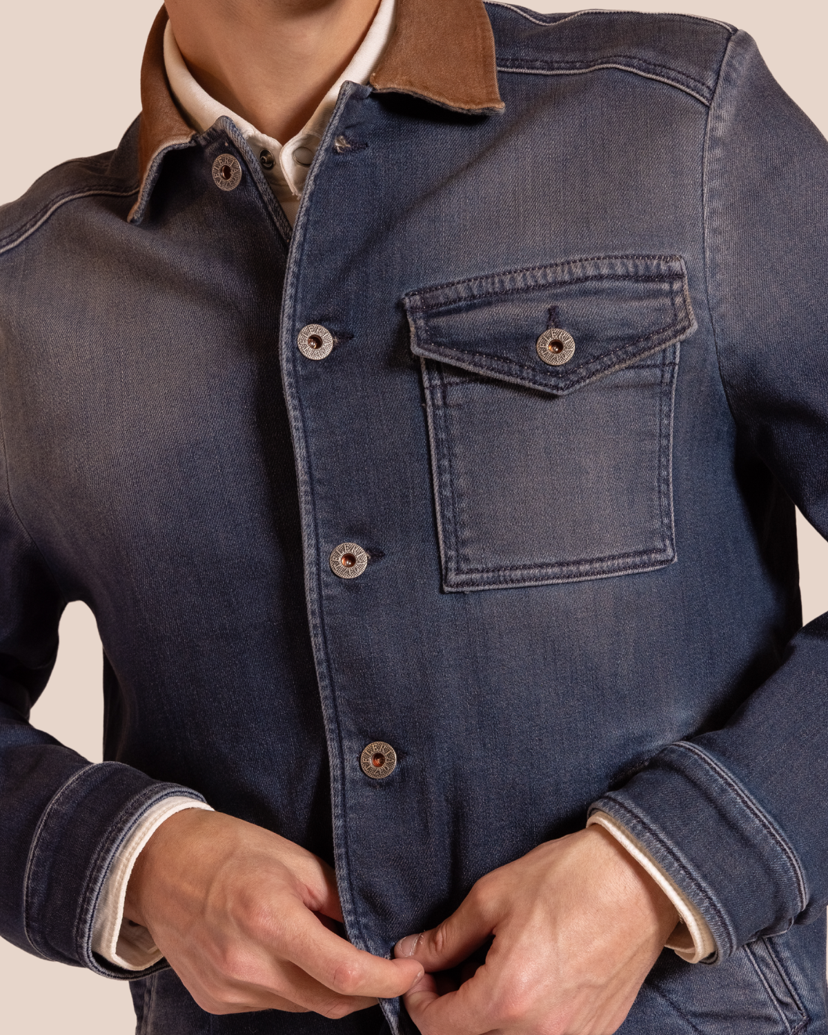 Hyde Dutton jacket detail — antique-finish buttons, flap chest pocket, tonal stitching and tobacco corduroy collar on washed indigo denim.