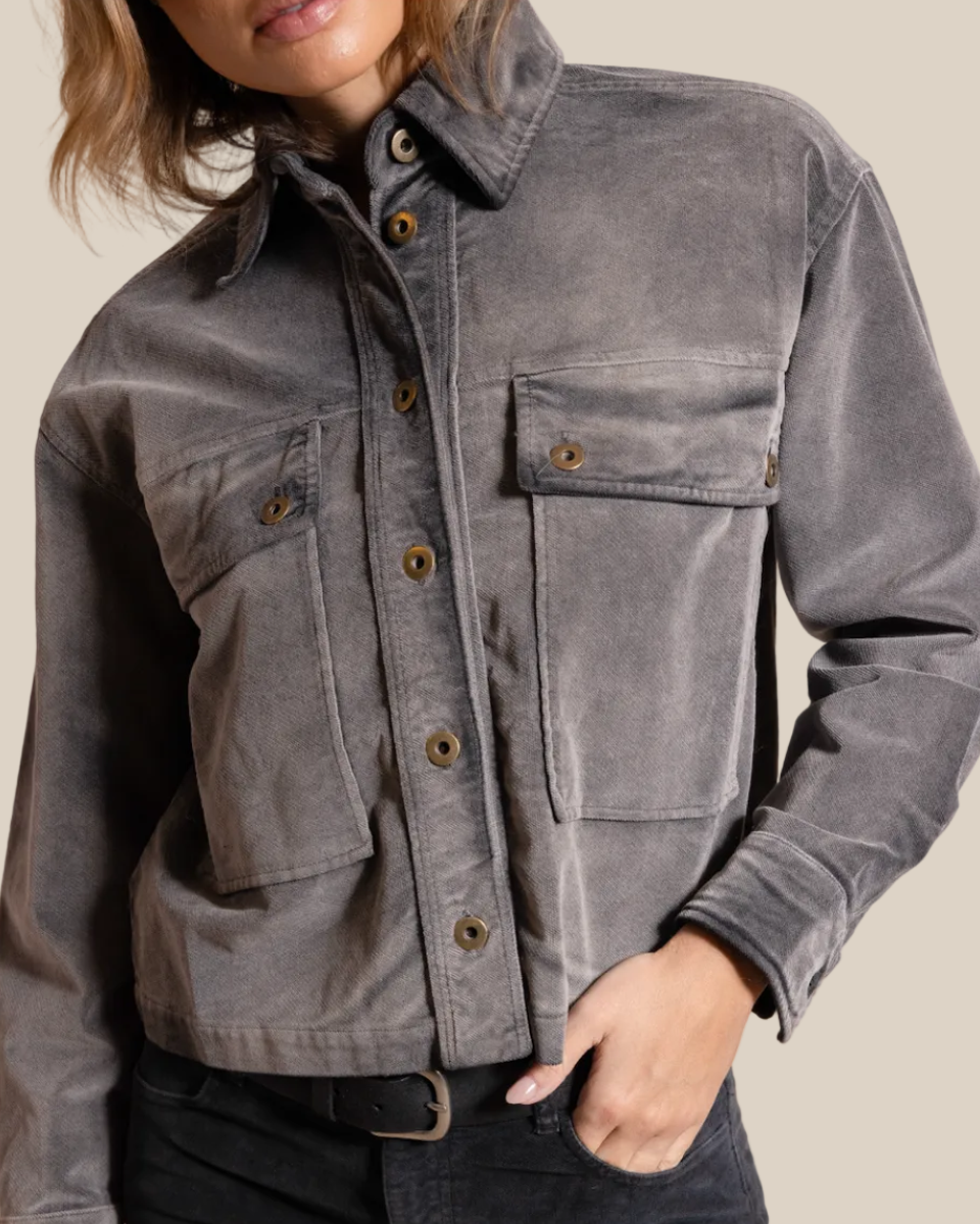 Gray jacket worn by a person on a beige background