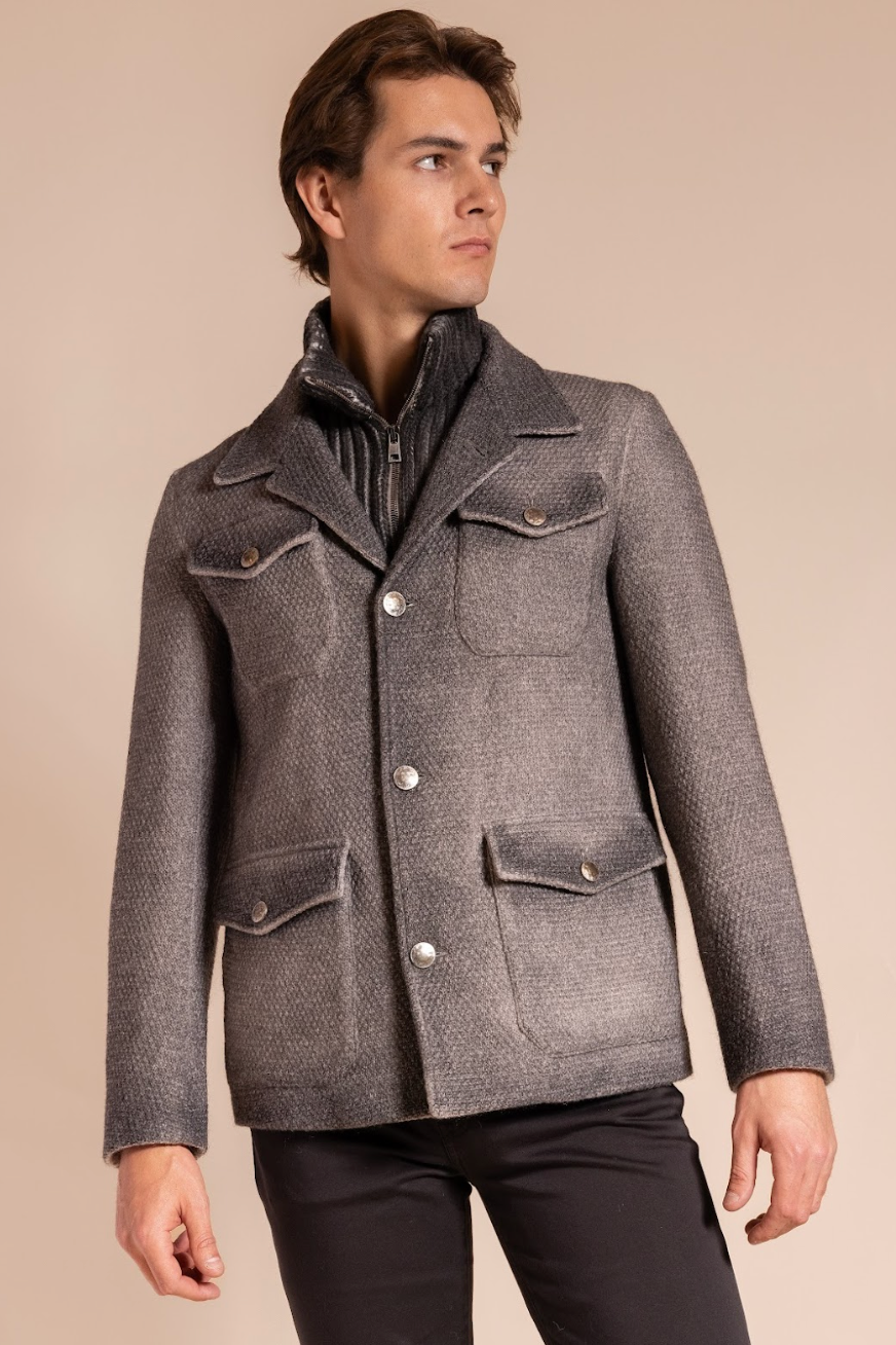 Man wearing a gray textured jacket on a beige background