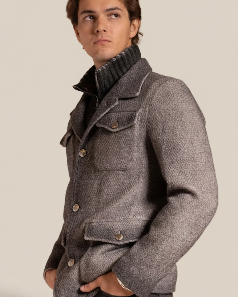 Man wearing a gray textured jacket against a beige background