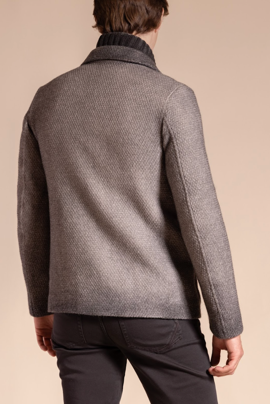 Man wearing a gray textured jacket on a beige background