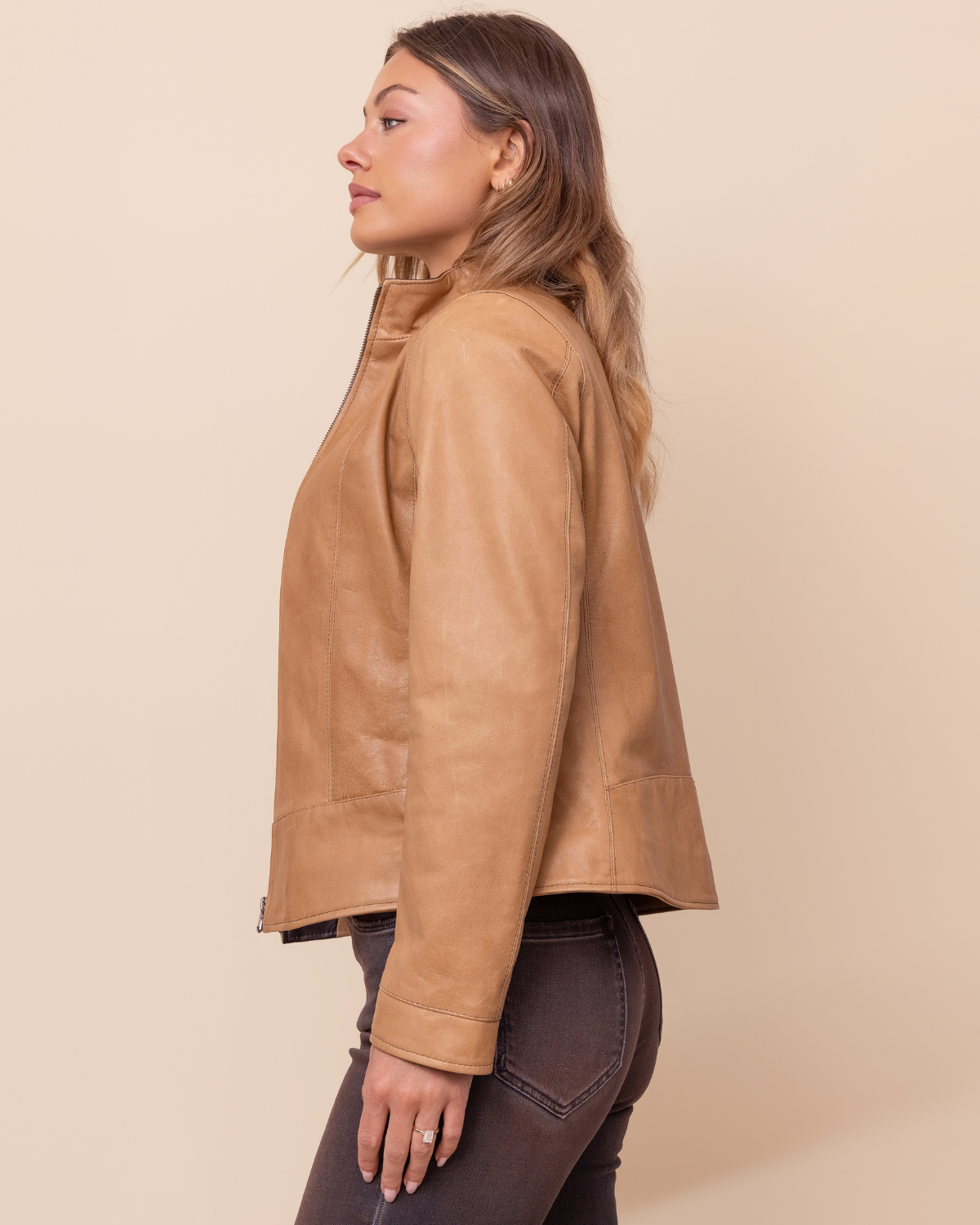 Woman wearing HYDE Sienna Sand Rustic waxy lambskin jacket — lightweight tailored fit, handcrafted in Los Angeles, sizes XXS–L