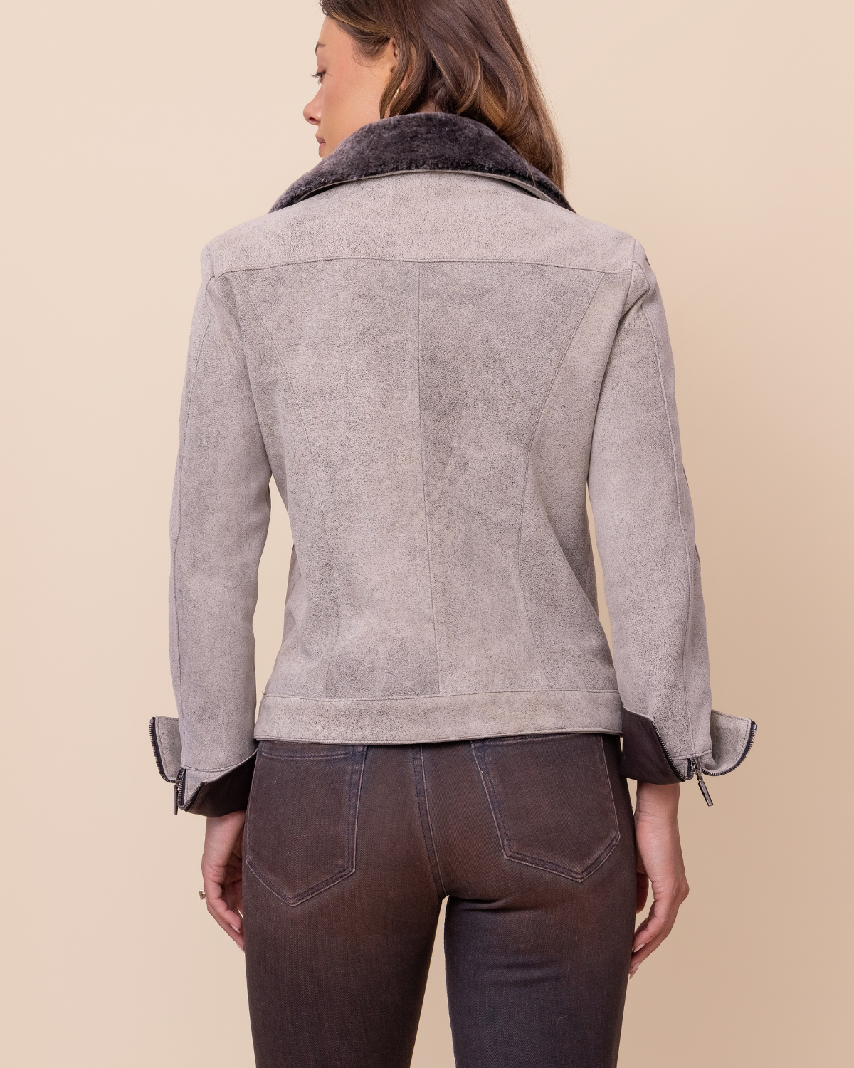 Woman wearing HYDE Elara Diego Rustic distressed lambskin jacket — sculpted tailored silhouette, shearling collar, USA-made