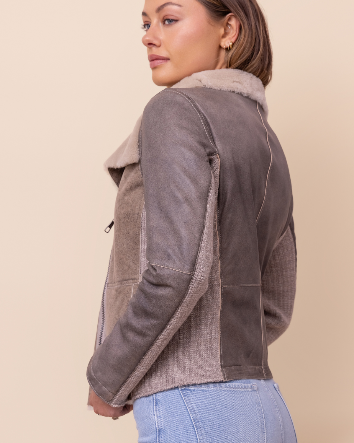 asymmetrical zip and sculpted collar close-up