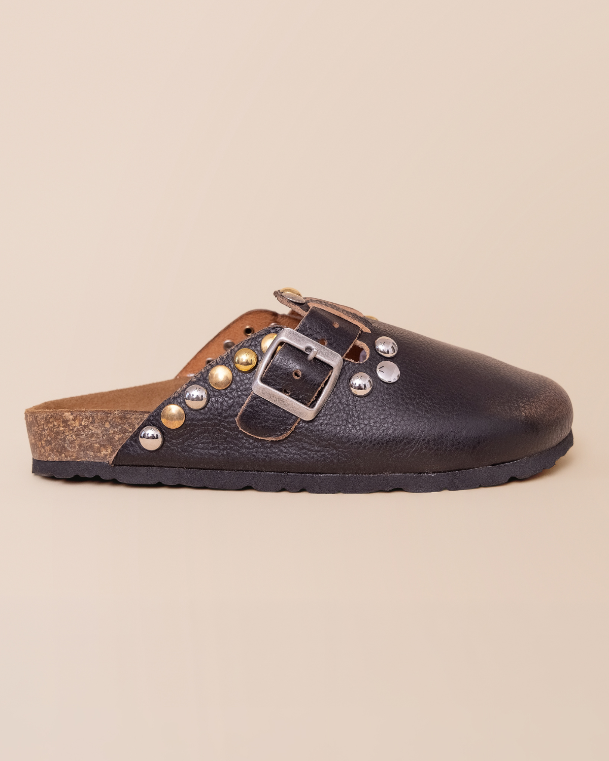 side profile — silver dome studs and antiqued buckle strap