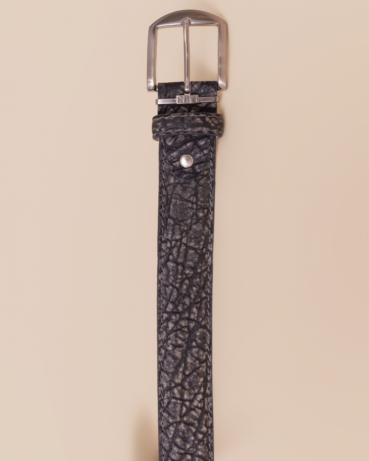 detail — polished nickel buckle and tonal hand-burnished edges