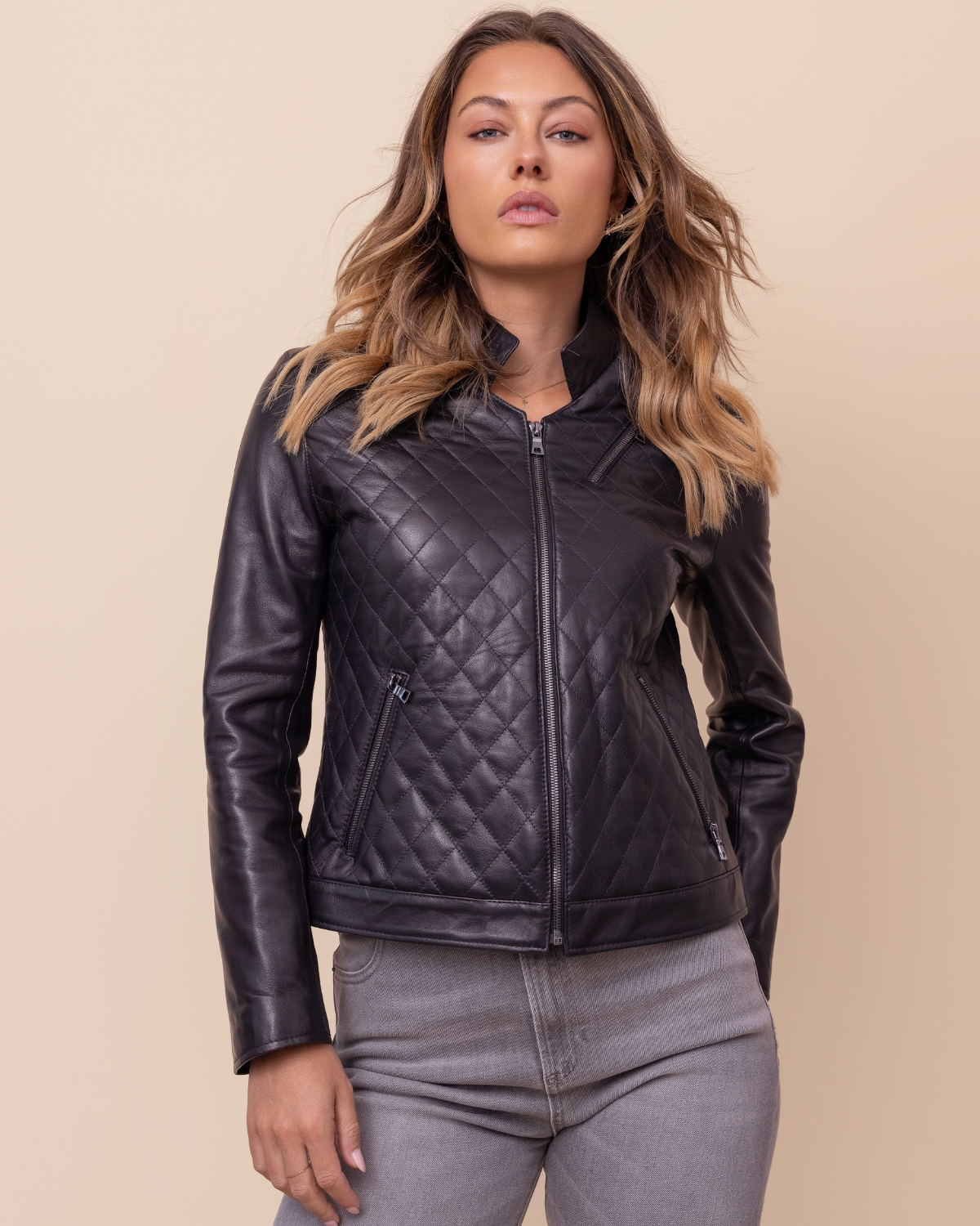 Woman wearing HYDE Carbon Noir quilted lambskin jacket — quilted black body with Napa sleeves, tailored fit, USA-made