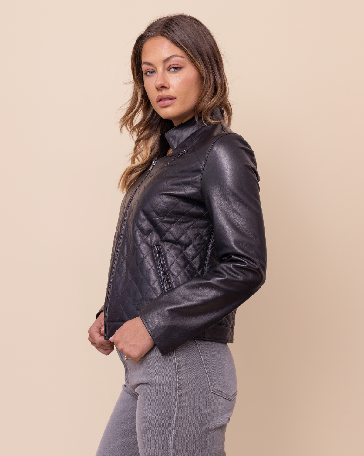 Woman wearing HYDE Carbon Noir black lambskin jacket — quilted body and smooth Napa sleeves, handcrafted in Los Angeles