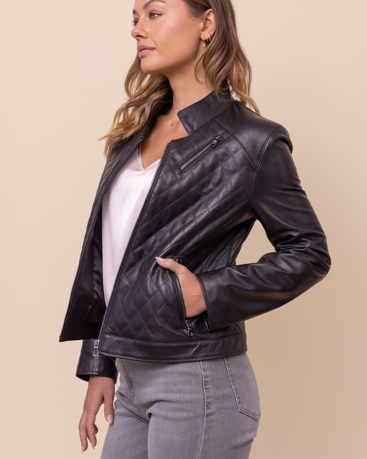 Woman wearing HYDE Carbon Noir black quilted lambskin jacket — stand collar and zip front, USA-made, sizes XXS–L