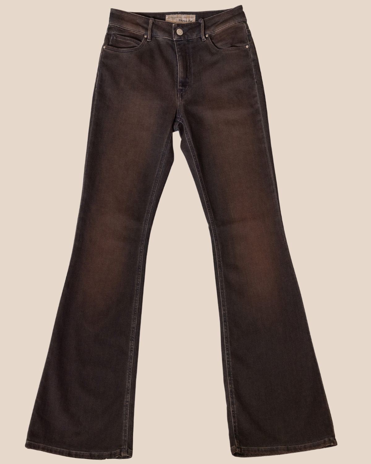 Brown flared jeans on a beige background