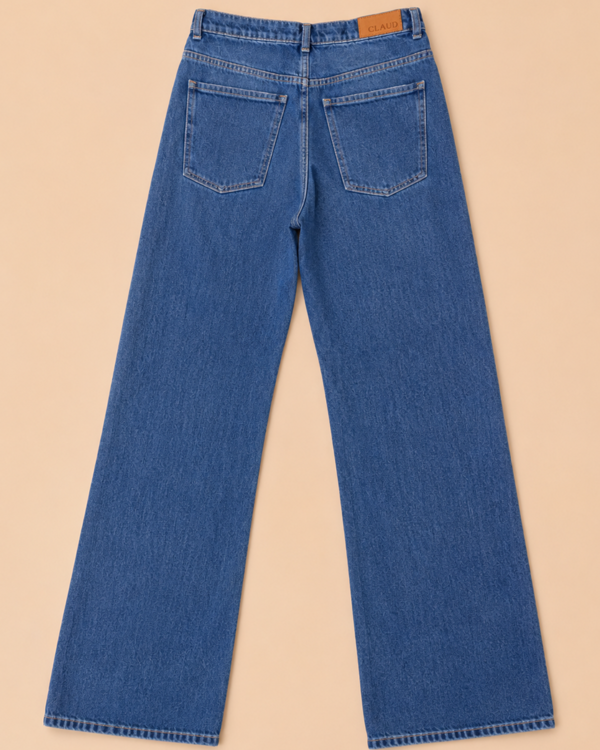 Blue jeans on a beige background