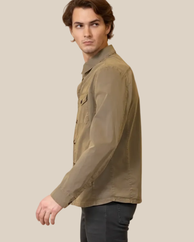 Man wearing a green jacket on a beige background