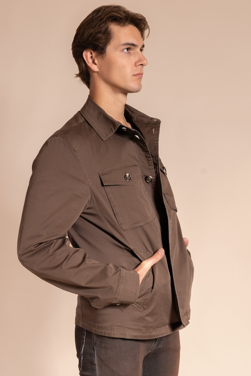 Man wearing a brown jacket on a beige background