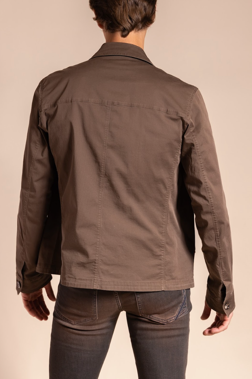 Brown jacket worn by a person on a beige background