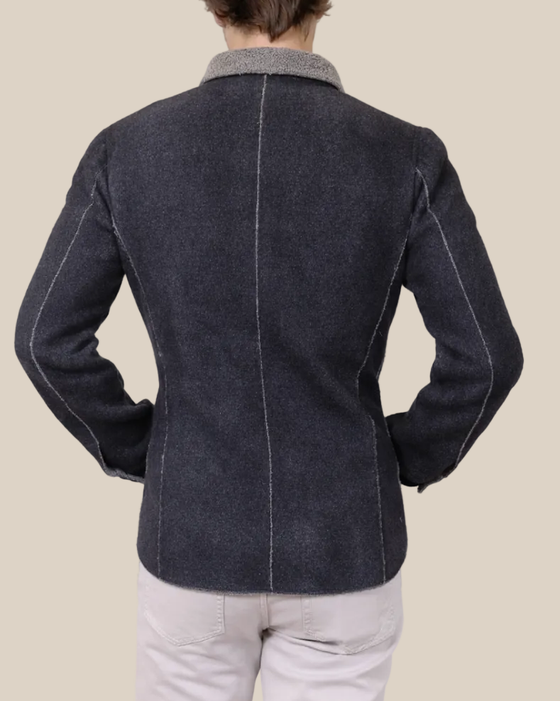 Person wearing a dark gray jacket with a white background