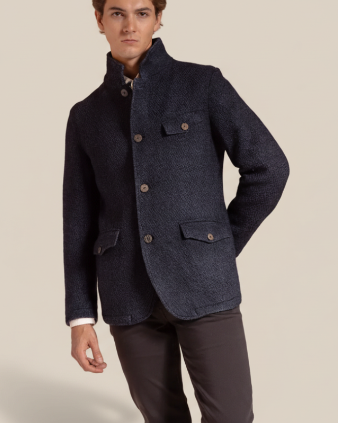 Man wearing a dark blue jacket on a beige background