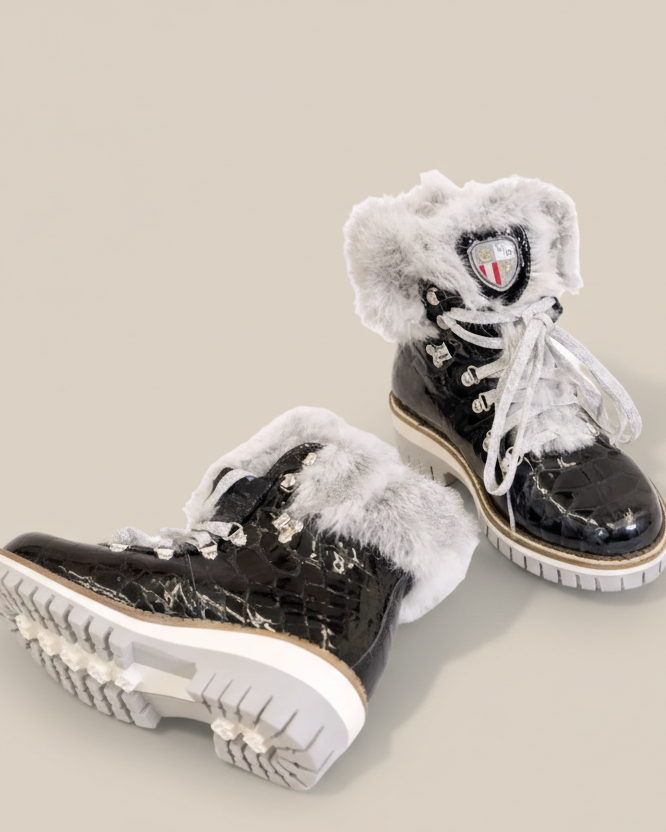 Black high-top sneakers with white fur lining on a white background
