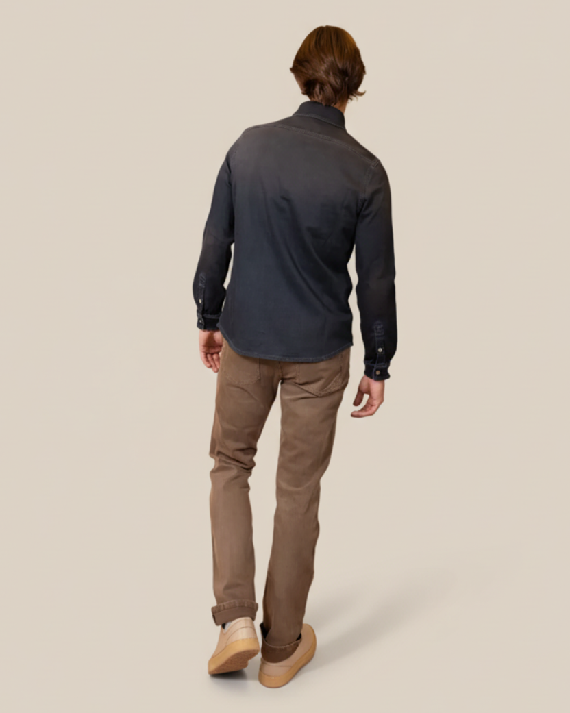 Person wearing a dark long-sleeve shirt and brown pants on a beige background