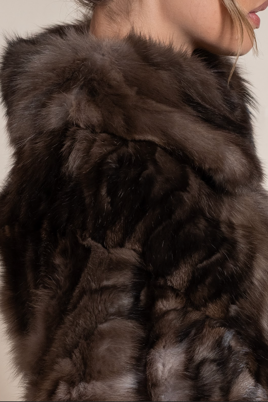 Close-up of a brown fur garment with a neutral background