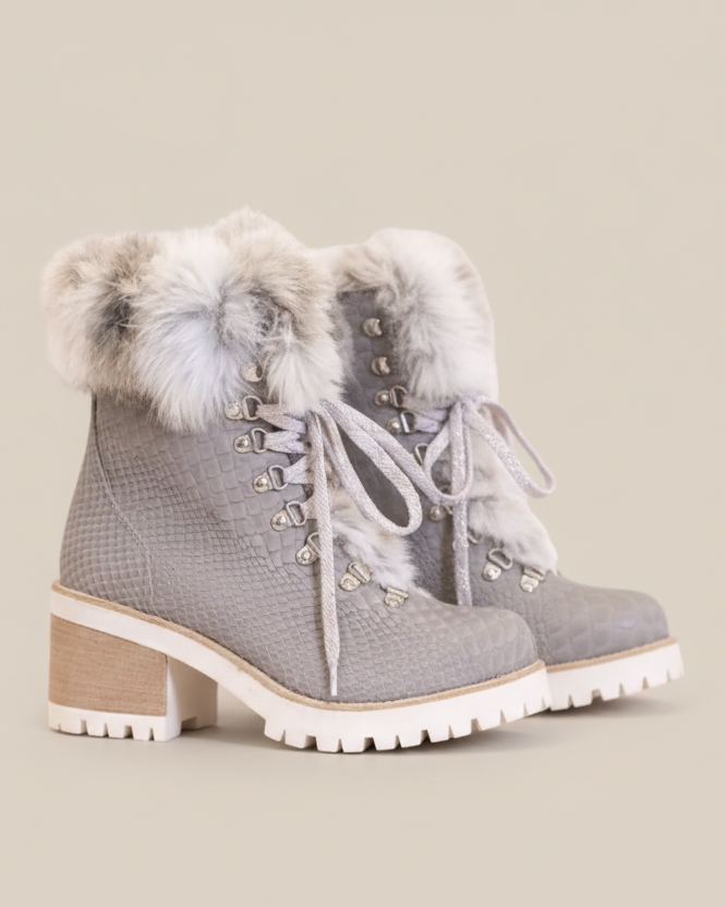 Gray boots with fur trim and decorative laces on a white background