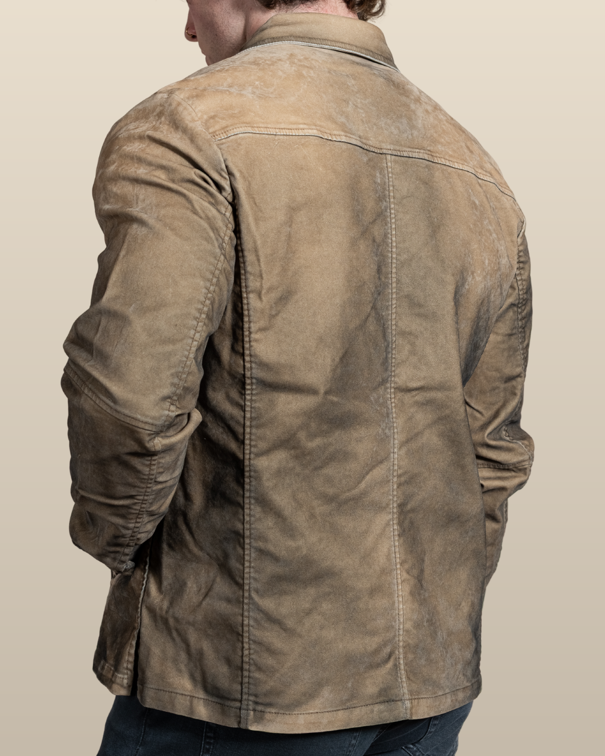Back view of the HYDE Sawyer moleskin trucker jacket in desert showing the Western back yoke and overdyed, sandblasted finish