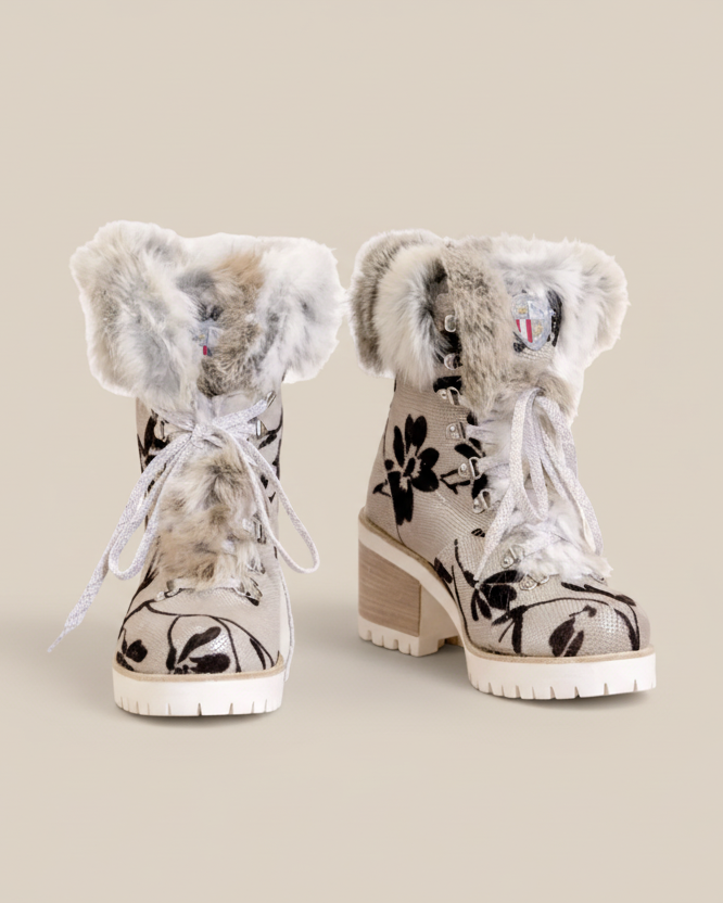 Pair of winter boots with floral design and fur trim on a white background