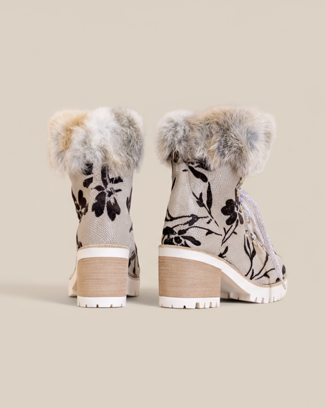 Pair of floral-patterned boots with fur trim on a white background