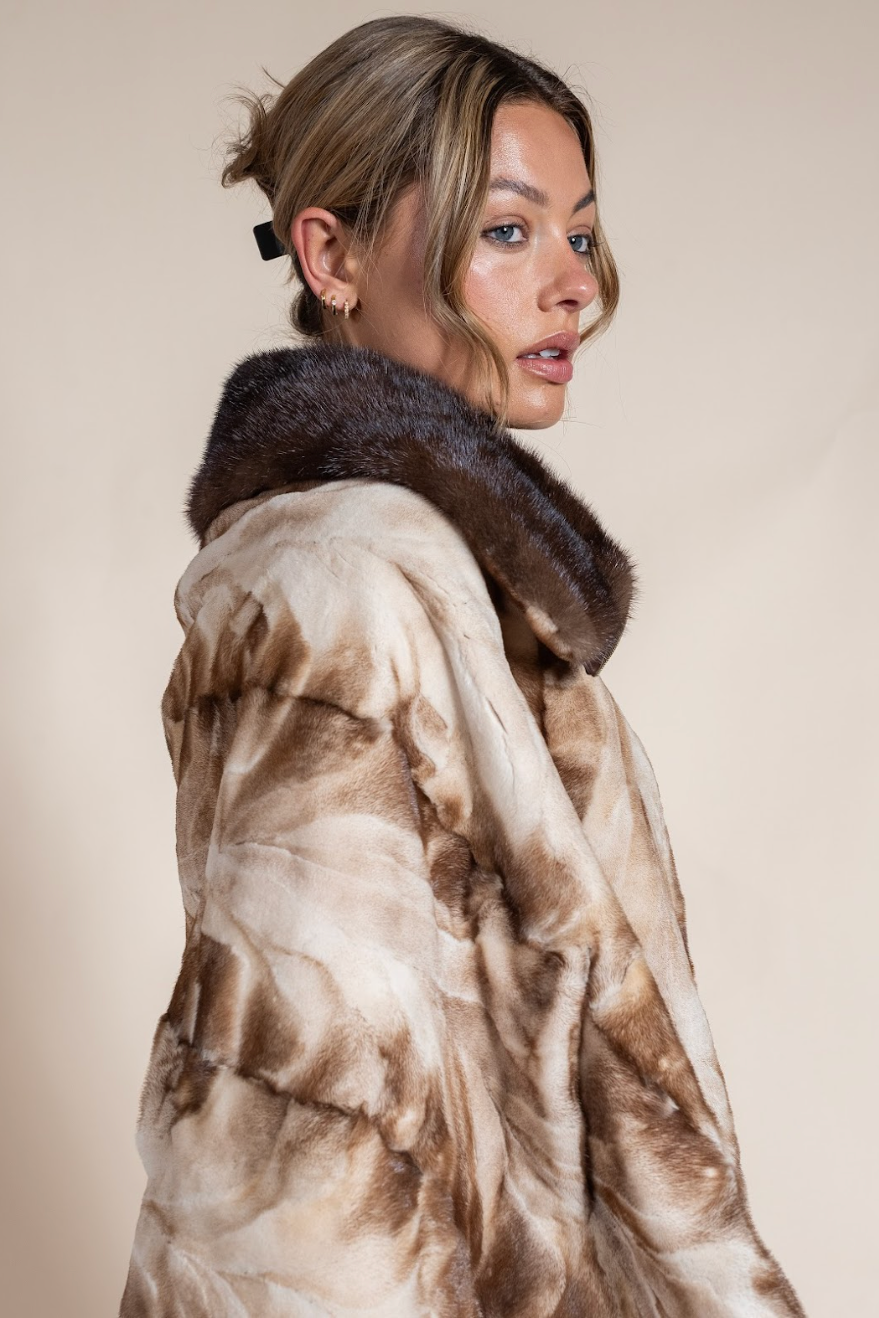 Woman wearing a fur coat with a neutral background