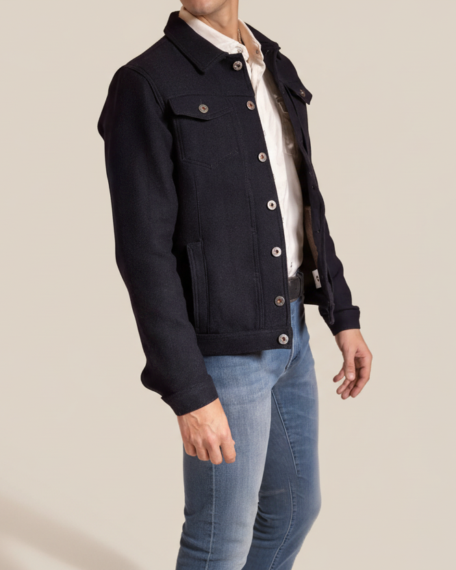 Navy jacket worn by a person on a beige background