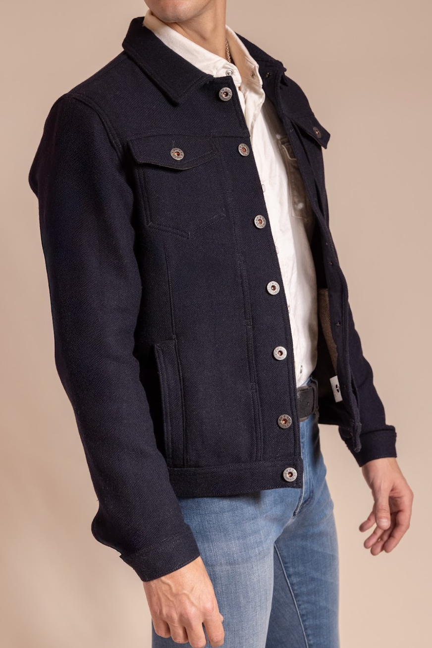 Navy jacket worn by a person on a beige background