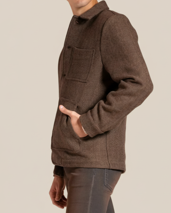 Man wearing a brown jacket on a beige background