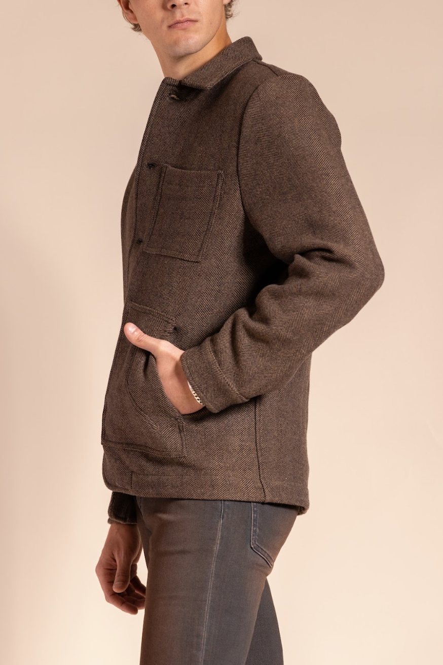 Man wearing a brown jacket on a beige background