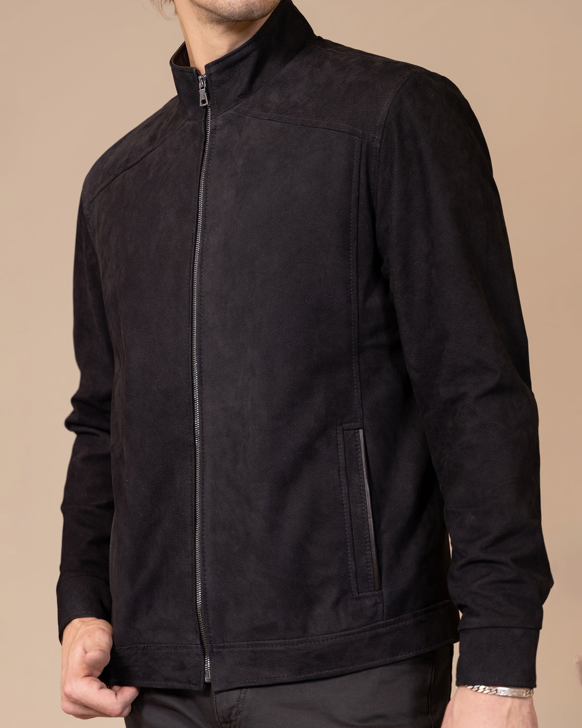 Close-up detail of the Savio Ace Rustic jacket's nubuck calfskin texture, showing the brushed matte finish and natural grain.