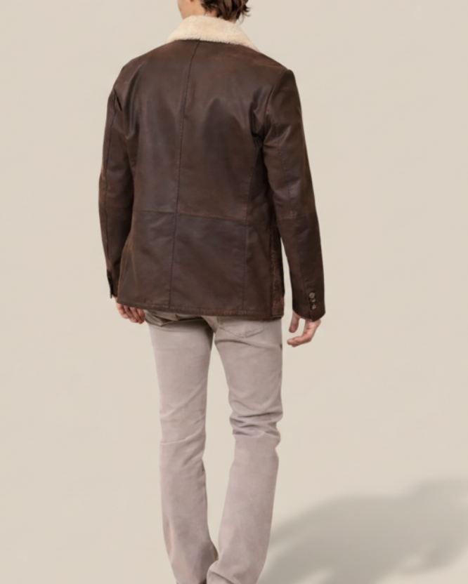 Person wearing a brown leather jacket and gray pants on a white background