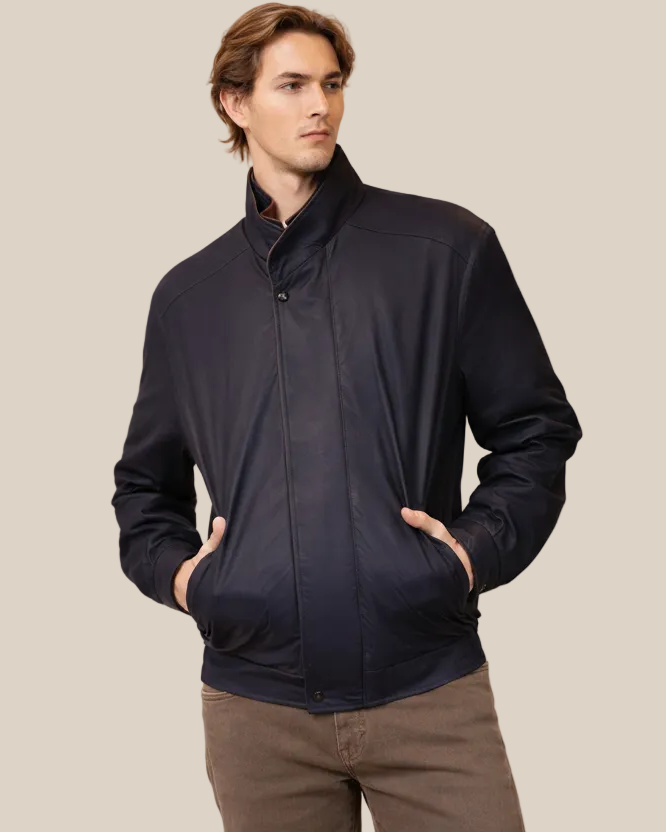 Man wearing a dark jacket on a beige background