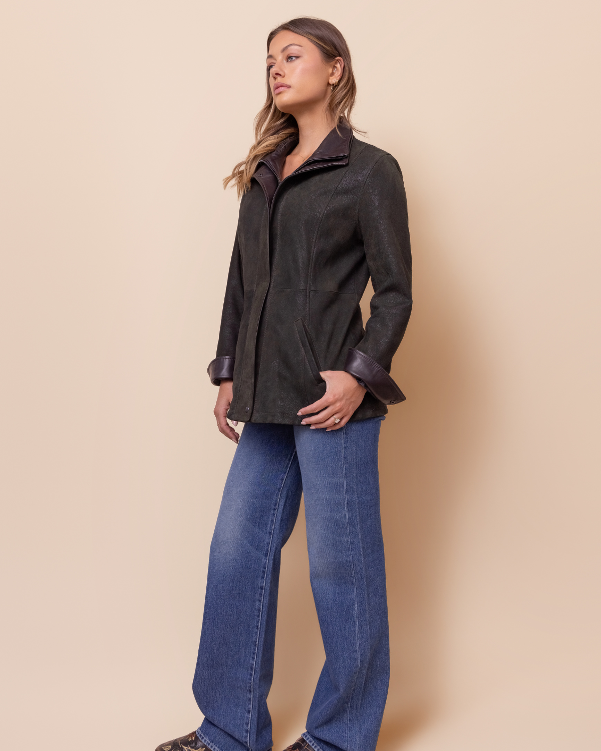 Woman wearing HYDE Cassia Moss Rustic distressed lambskin jacket — earthy moss green, tailored modern fit, sizes XXS–L