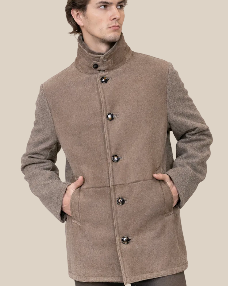Man wearing a brown coat with button details on a white background