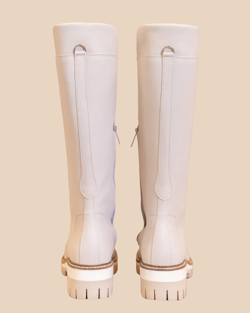 White knee-high boots on a beige background